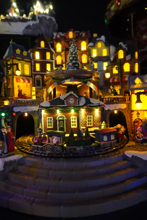 Un villaggio di Natale illuminato, con case e scalinata